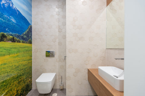 a modern bathroom with colourful wallpaper beside a bidet