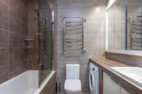 Contemporary bathroom interior with bathtub and toilet bowl