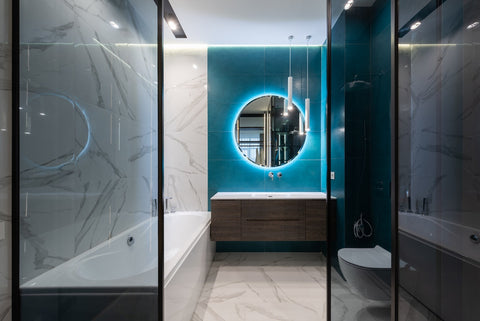 Contemporary interior of bathroom with bathtub and round mirror