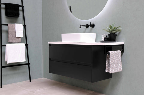 white ceramic basin beside a black towel rack