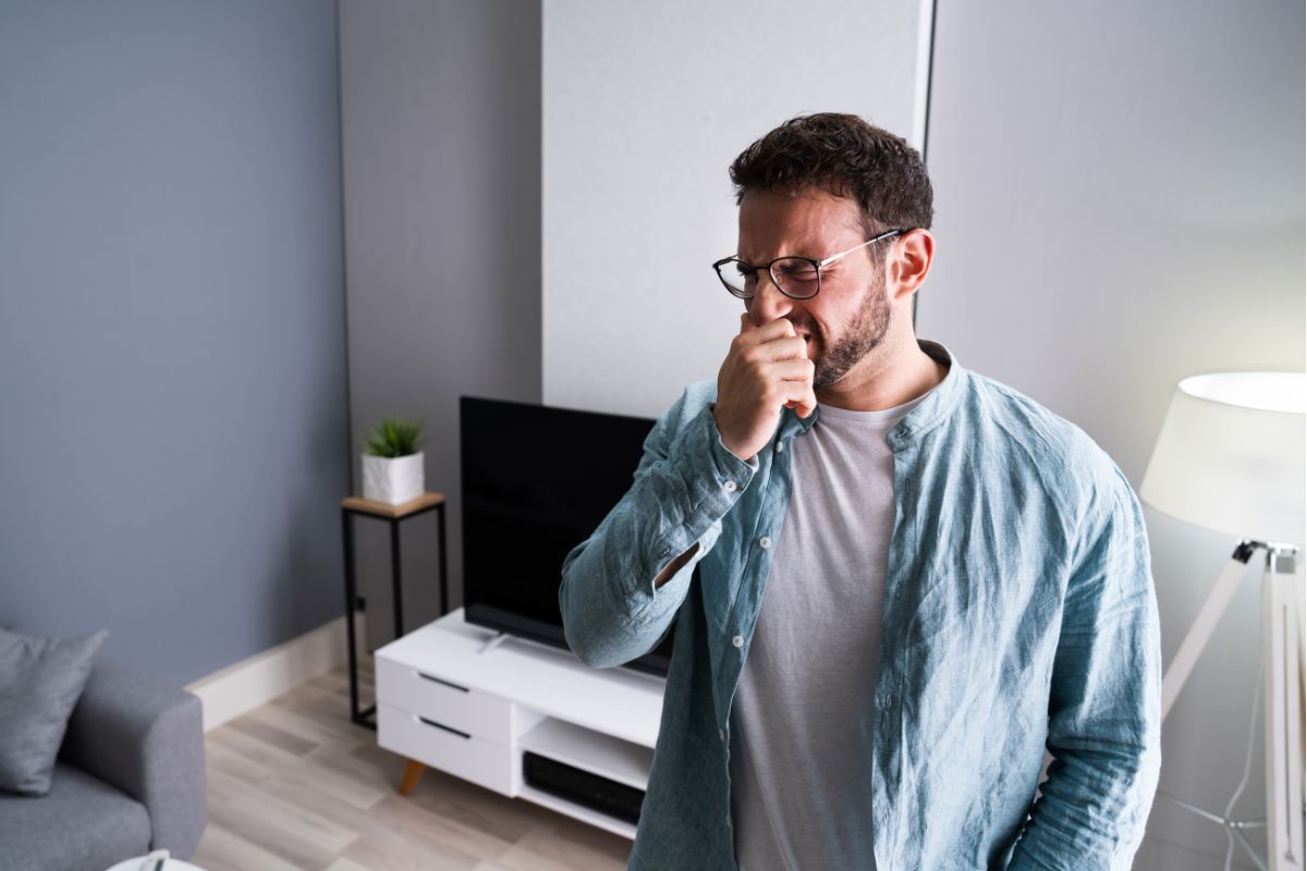 man smelling foot odor