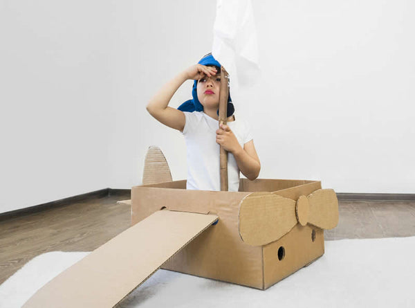 Children Playing in cardboard boxes