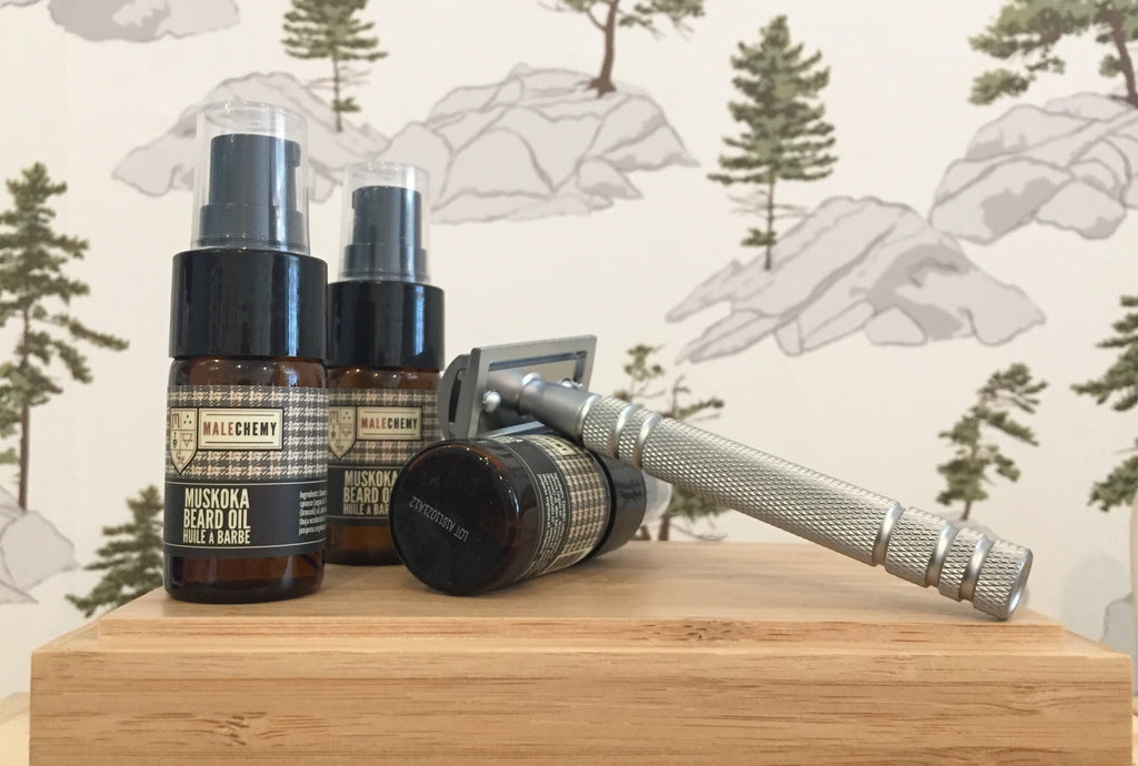 Three small bottles of Malechemy Muskoka beard oil and a brass safety razor