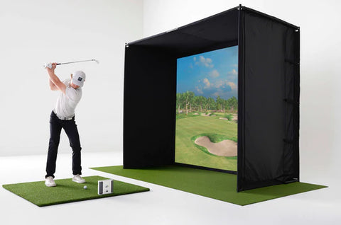 A golfer is captured mid-swing, using a Skytrak+ Launch Monitor to analyze and enhance their performance. The golfer is positioned in a golf simulator bay, with a projector attached to the top of the enclosure. The projector displays a vivid image of a virtual golf course, creating an immersive experience. The Skytrak+ Launch Monitor is actively tracking the swing, providing real-time data for training and simulation purposes.