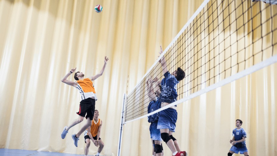 Men in volleyball equipment playing