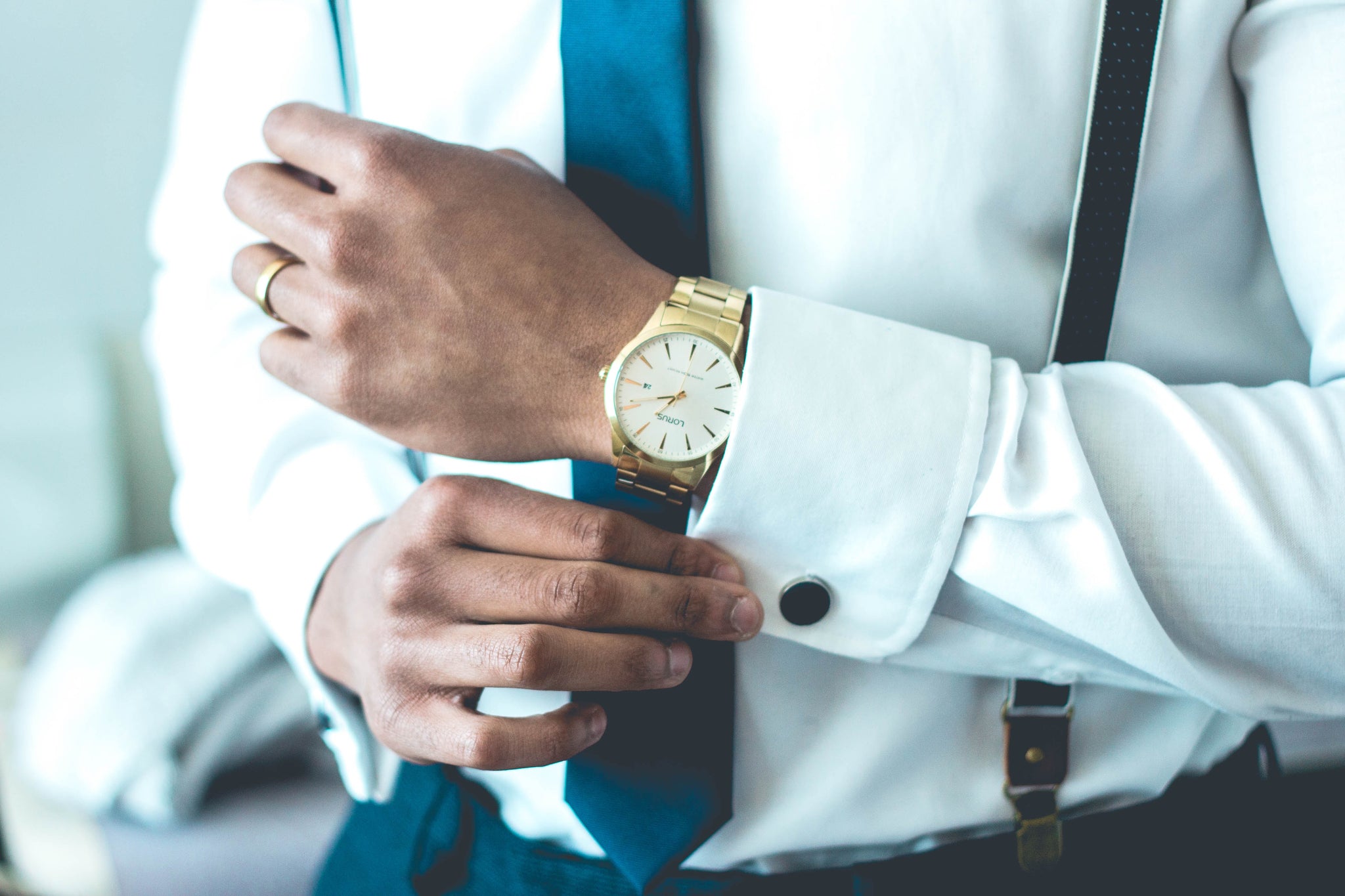 A man fixing his cufflinks