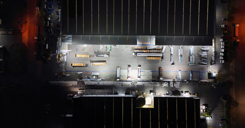 Birds eye view of industrial truck loading area with LED lighting