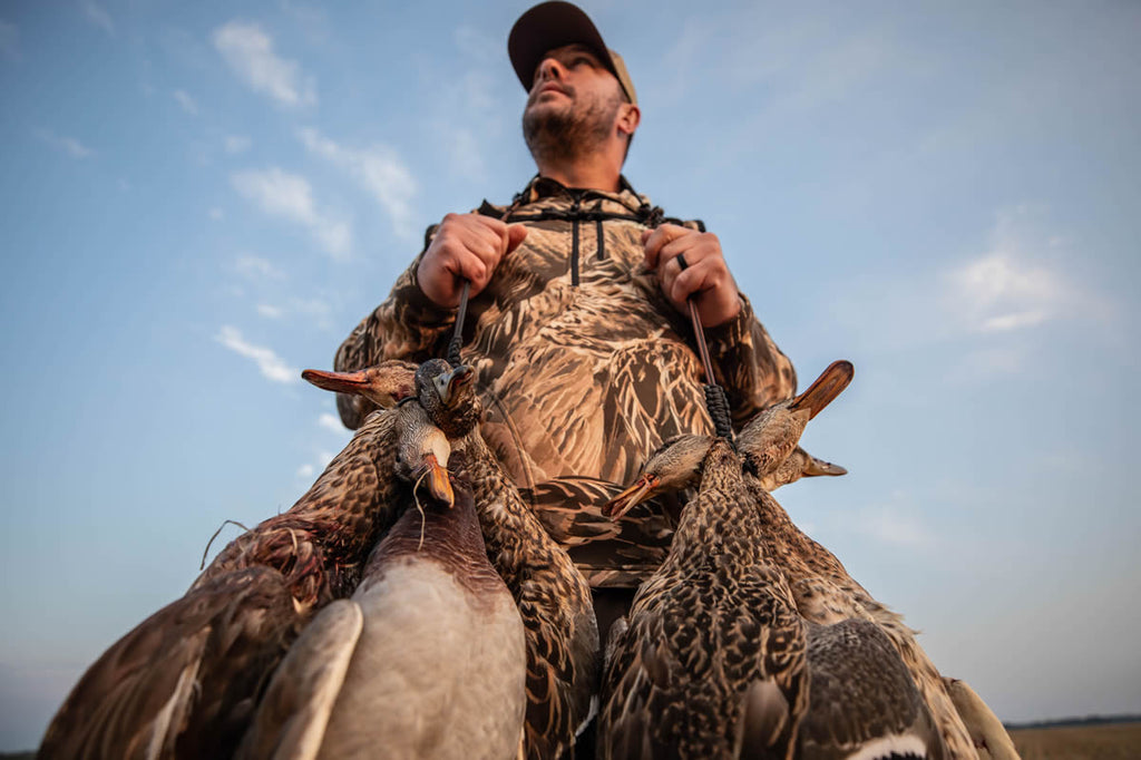 AVES Refuge Camo with ducks around the neck looking up to the sky