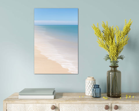 tablescape with abstract beach photo above including teal water blue skies and waves on sandy shore