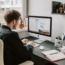 Person using indoor earthing products to help them get more earthing connection during the day. Earthing mat on a desk in front of a computer.