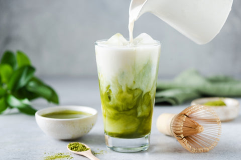 pouring milk into matcha tea