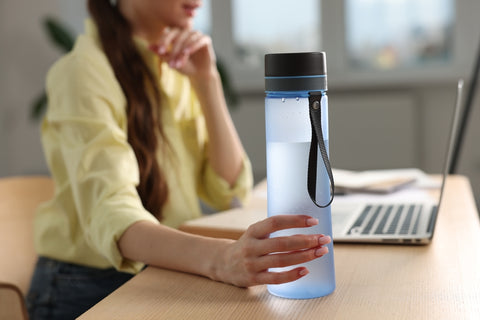 woman holding reusable water bottle