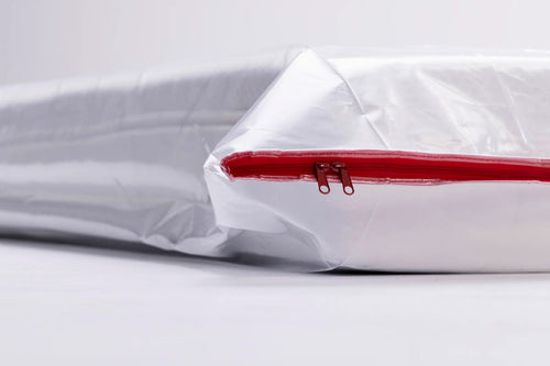 close up of the mattress bag with a queen mattress inside and the zip is closed