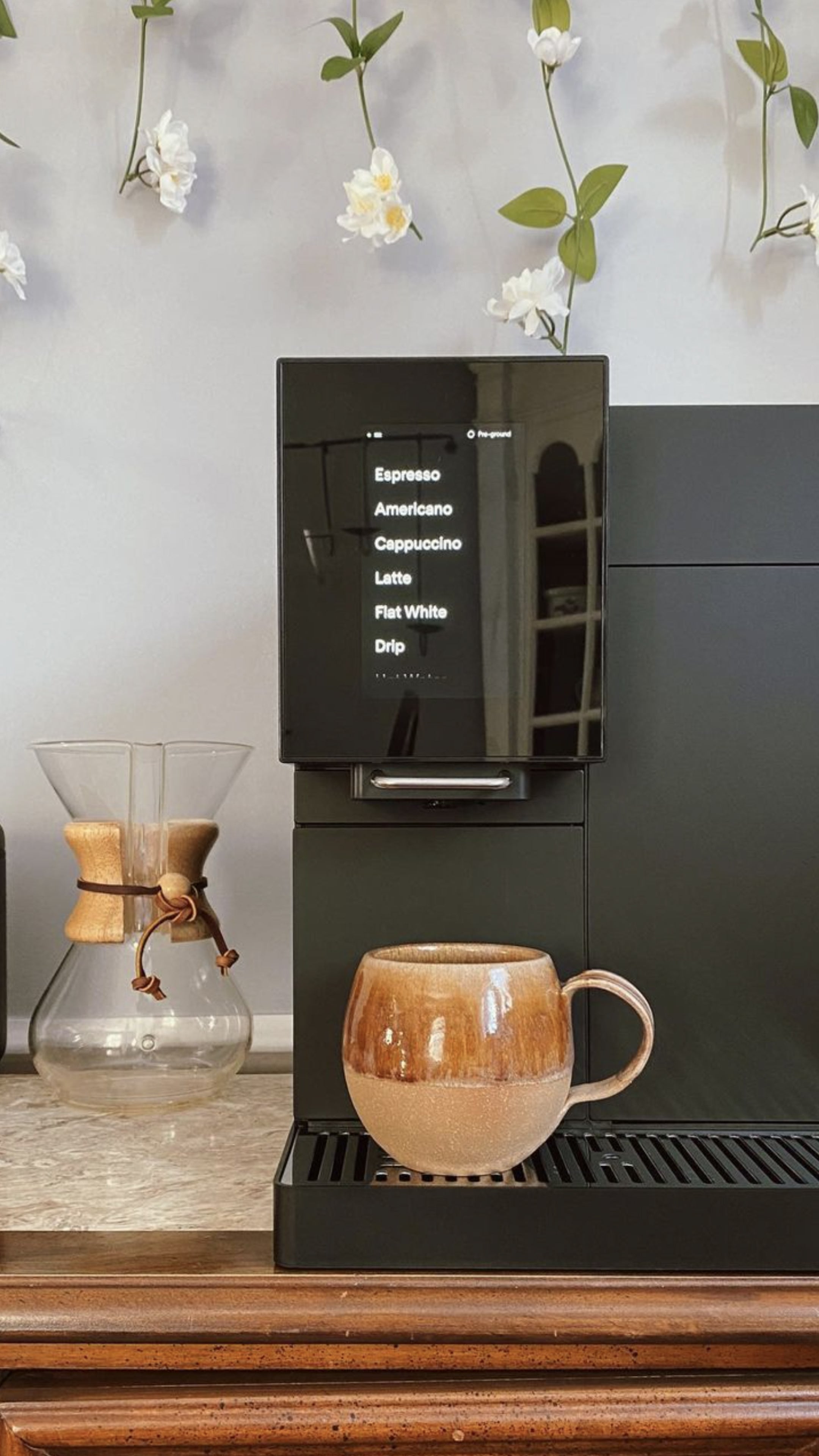 Black TK-02 on counter with brown ceramic mug under spout