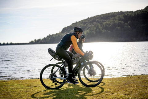 a couple riding on a bike