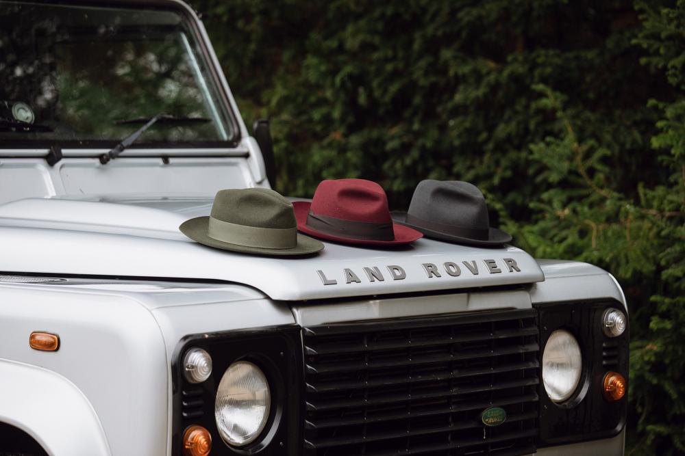 Three Christys' fedoras on a Land Rover