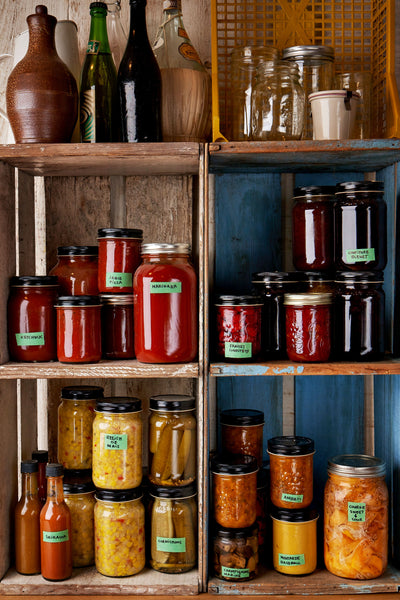 A shelf filled with a variety of preserves made by Jean-Simon