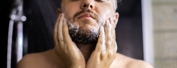 Closeup of man washing his beard