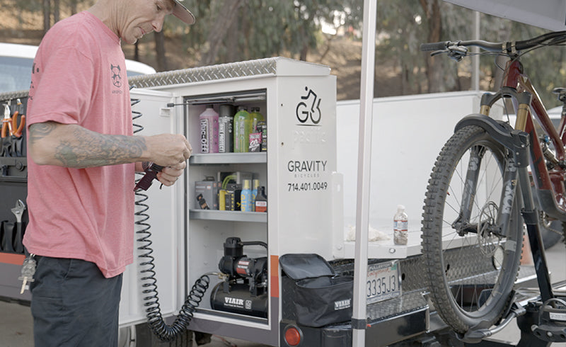 Bike mechanic setting up his TLC Boost Tire Inflation kit.