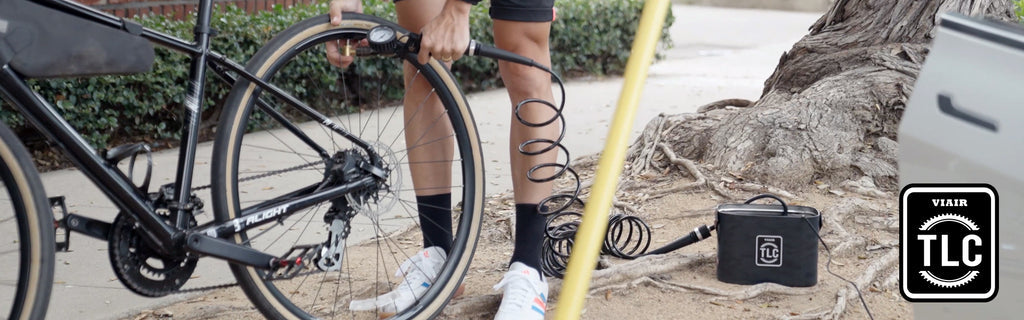 Bicyclist filling up tire with the TLC Lite Tire Inflator.