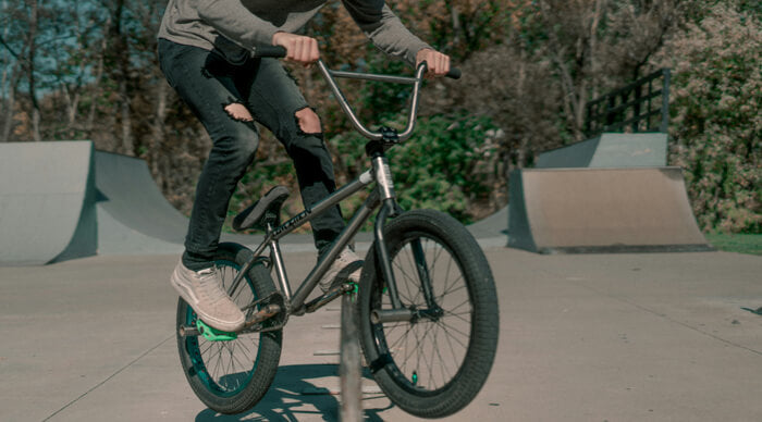 a man riding a small bike