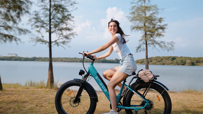 a woman rides an electric bike engwe e26