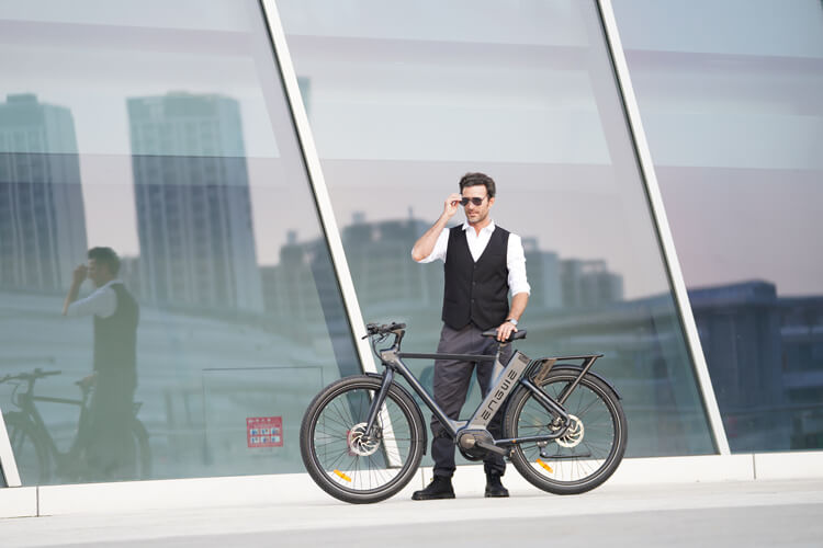 a gentleman stands next to the men's electric bike - engwe p275 pro