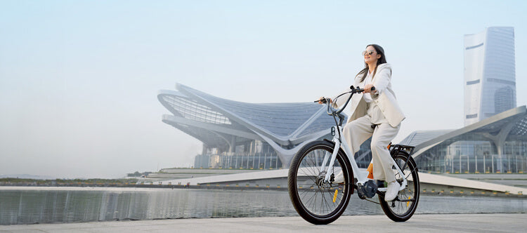 a woman rides a white-orange electric bike for adults engwe p275 st on the road