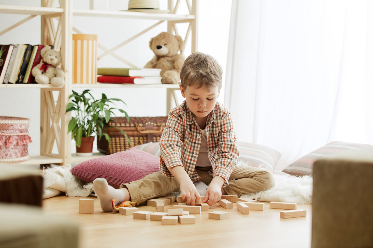 A boy playing with wooden blocks