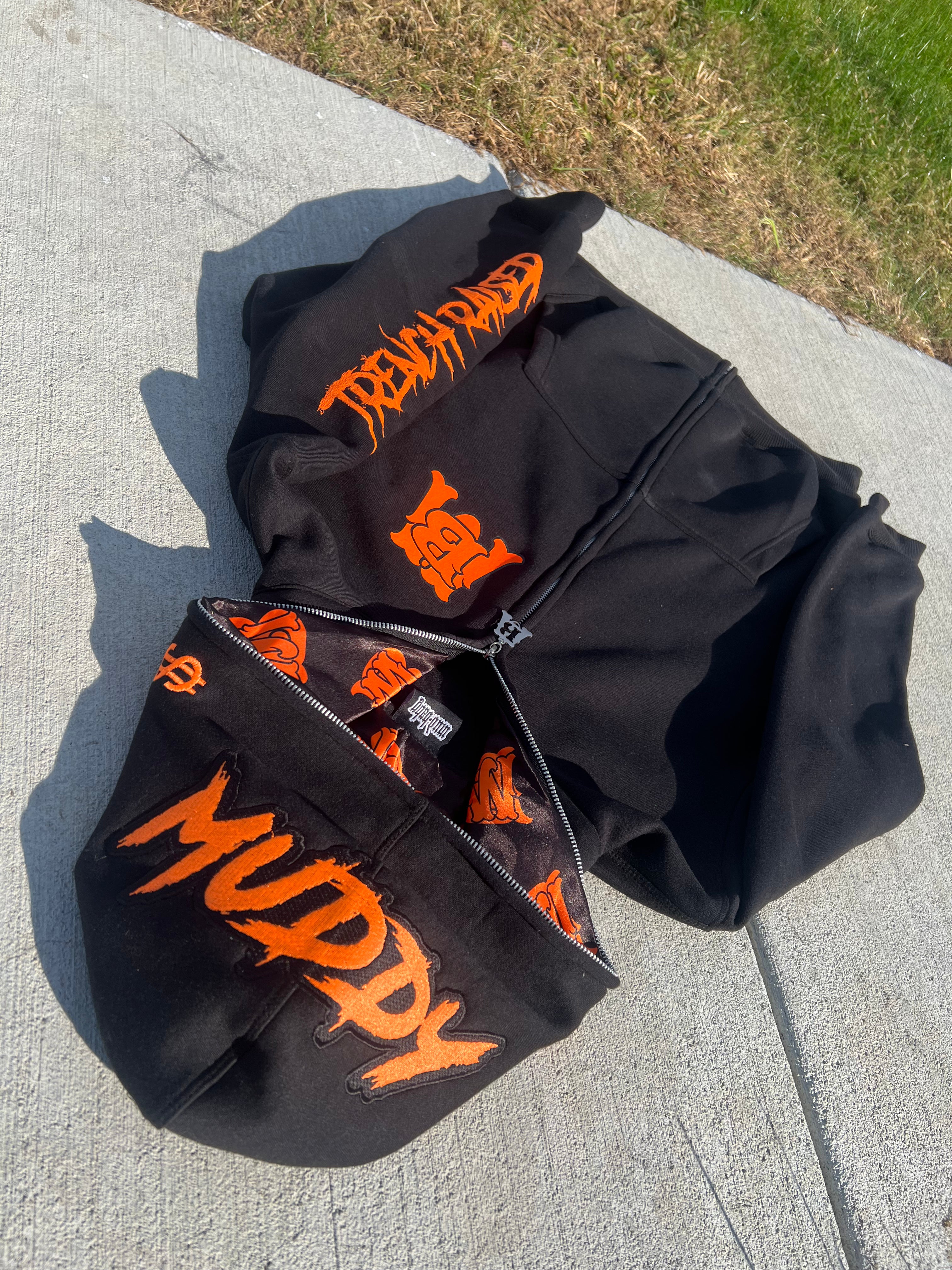 black and orange zip up