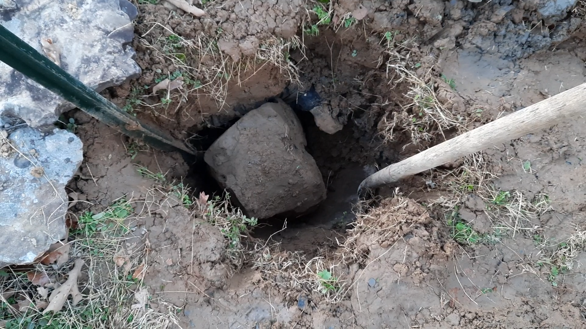 This post hole was especially problematic. We used an auger to dig as far as we could, then switched to shovels to manually remove this large rock we ran into so we could achieve the appropriate depth and width.