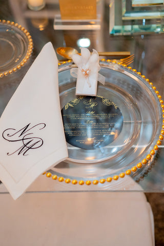 Embroidered Napkins and Circular Black and Gold Foil Menus for Black Tie Wedding