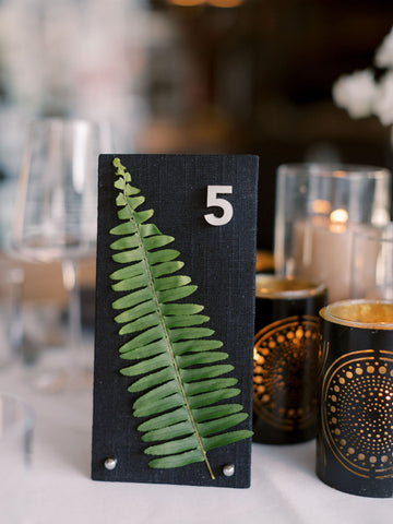 Unique modern custom table numbers cards with fabric wrapped cards and real greenery fern for fall wedding by lucky onion stationery photo by megan wynn photography