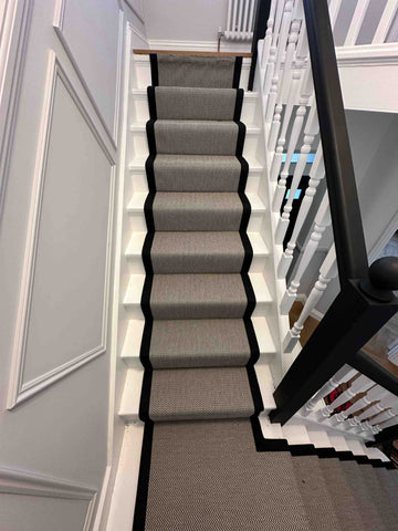 A hand-made black and white herringbone stair runner carpet