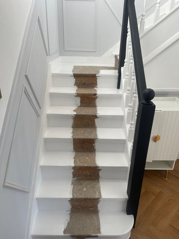 a white set of stairs ready for a runner fitting