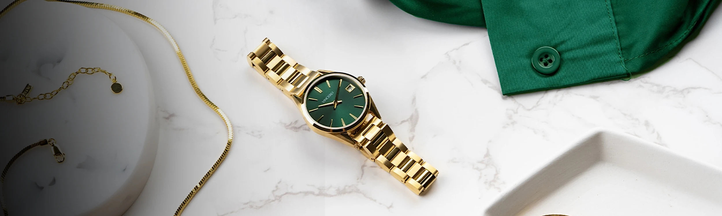 Four women's watches laying in white marble