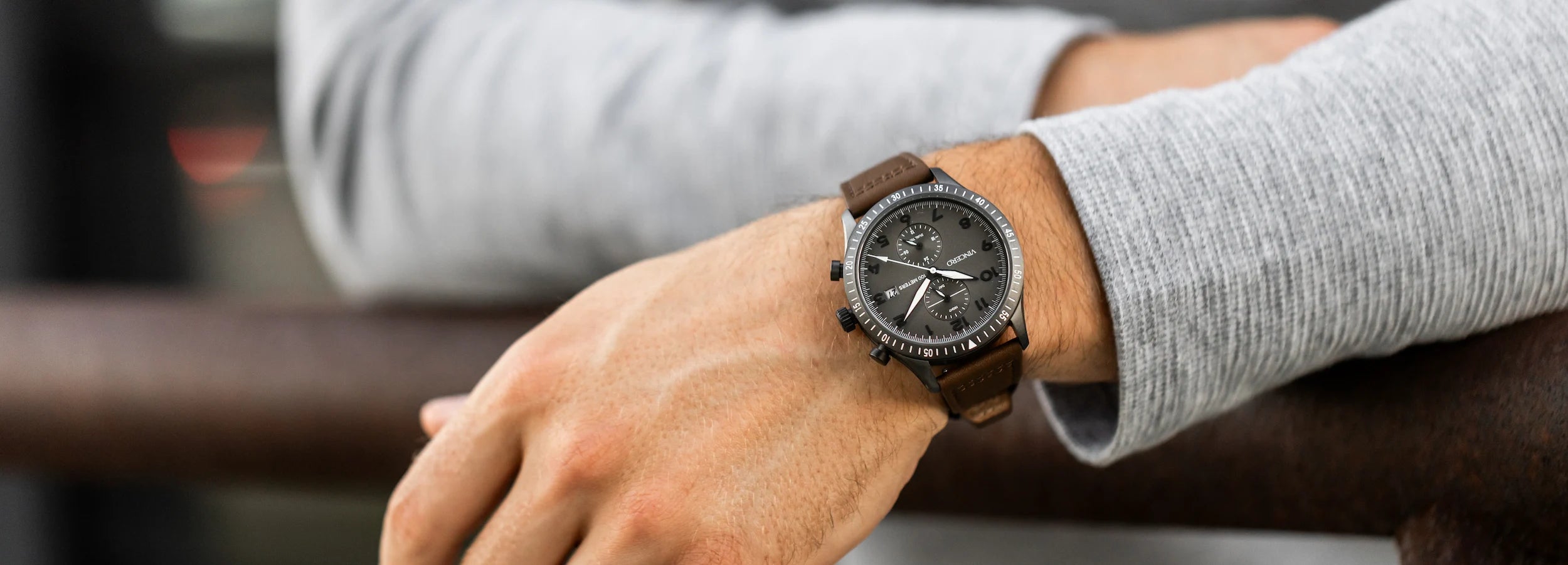 Close up of gunmetal watch in greyish black background