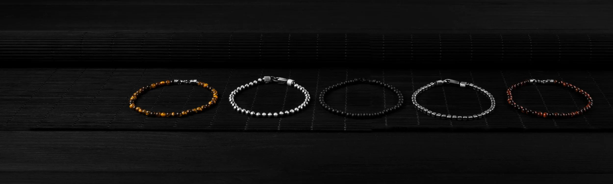 Three bracelets stacked in marble with black background