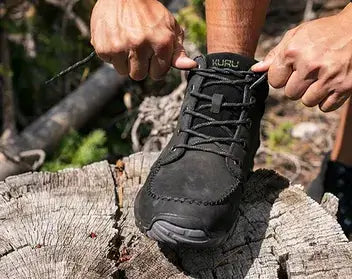 A man tying his KURU QUEST boots.