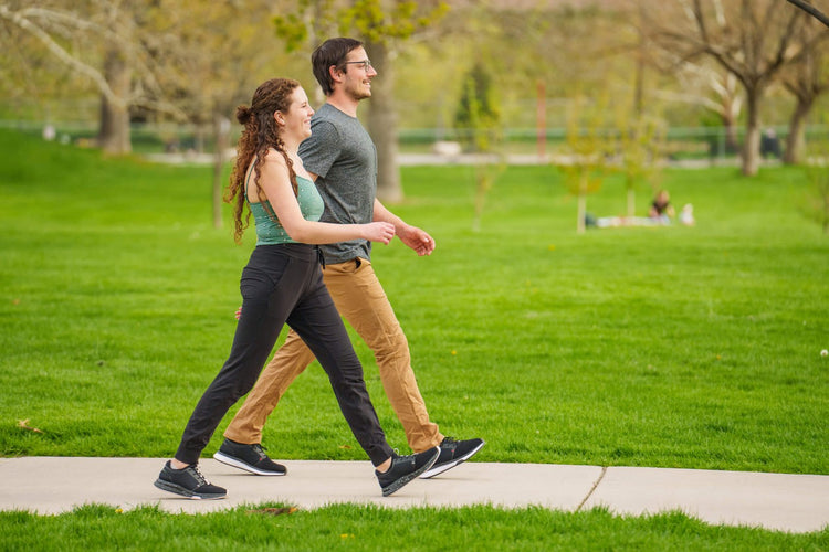 A couple wearing KURU ATOM shoes for Disney walking through the park.