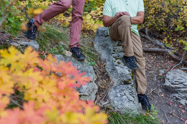 A couple wearing KURU CHICANE outdoor shoes hiking on a fall day.