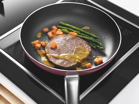 Teflon coated cookware on an induction hob. Photo by Cooker King.