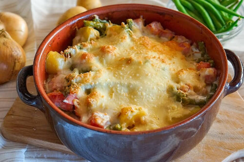 Clay pot casserole with cheesy baked dish served. Photo by m_krohn.