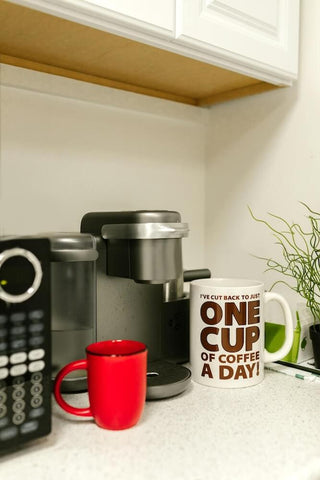 Coffee mug with coffee maker. Photo by RDNE Stock project.