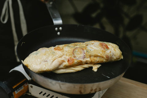 Cooking omelette on a traditional Teflon non-stick pan. Photo by Klaus Nielsen.