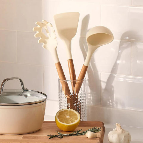 Cosmic Cookware silicone cooking utensils in cream.