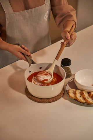 Serving creamy tomato soup from the Cosmo Saucepan with the Cosmo Ladle.