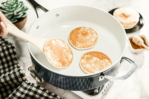 Even heat distribution allows for easy cooking of mini pancakes on the Cosmo Pan.