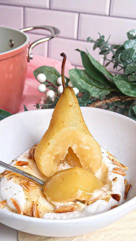 A quick peek into a bite of tender poached pear served with dairy-free coconut yogurt and a sprinkle of toasted almonds.