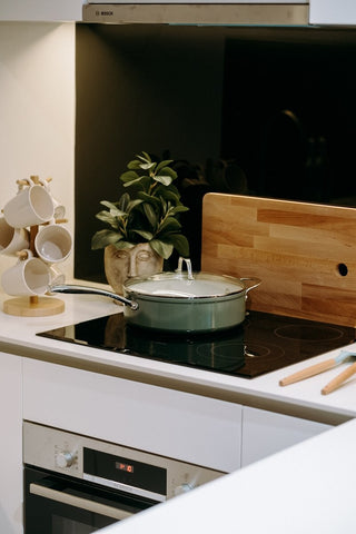 The Cosmo Pan, a ceramic pan, on an induction cooktop.